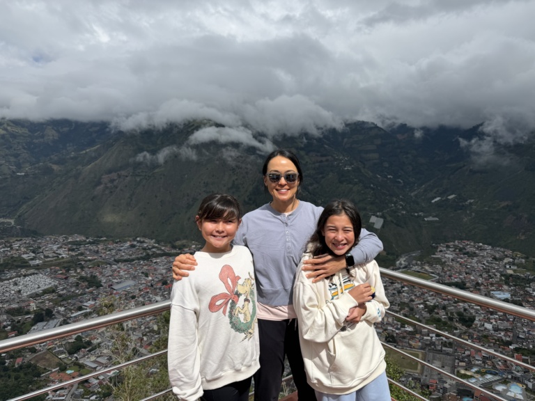 The family at a mountain overlook with low clouds behind