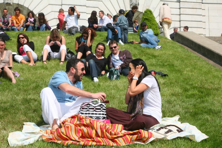 Friends and family picnicking together on a lawn