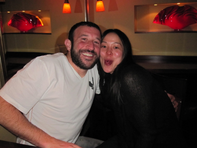A couple smiling together at an evening party