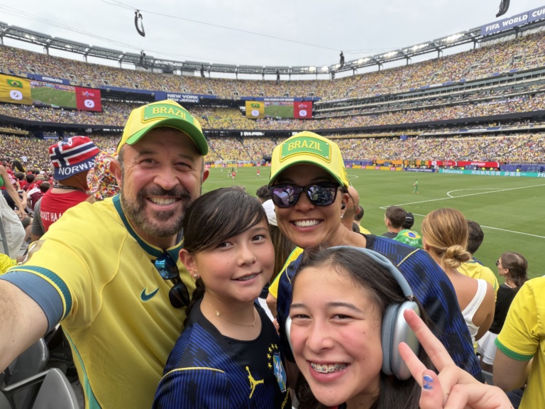The family in yellow and green jerseys at a packed stadium