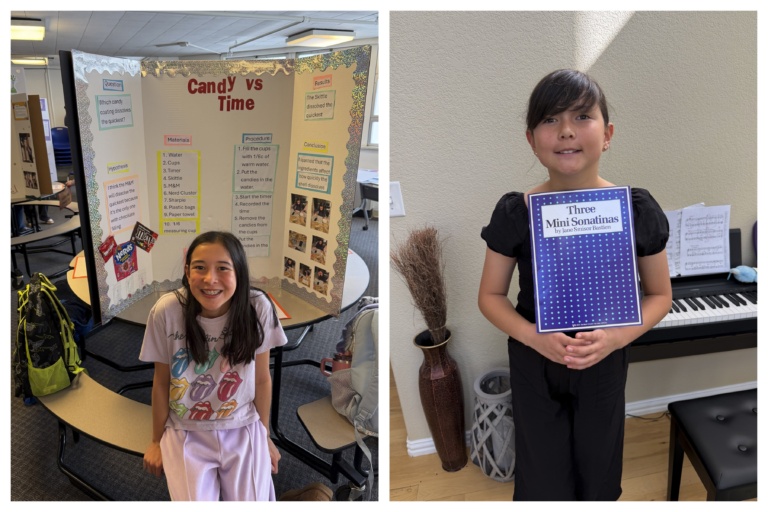 A girl with her science fair poster, and holding a binder beside a piano
