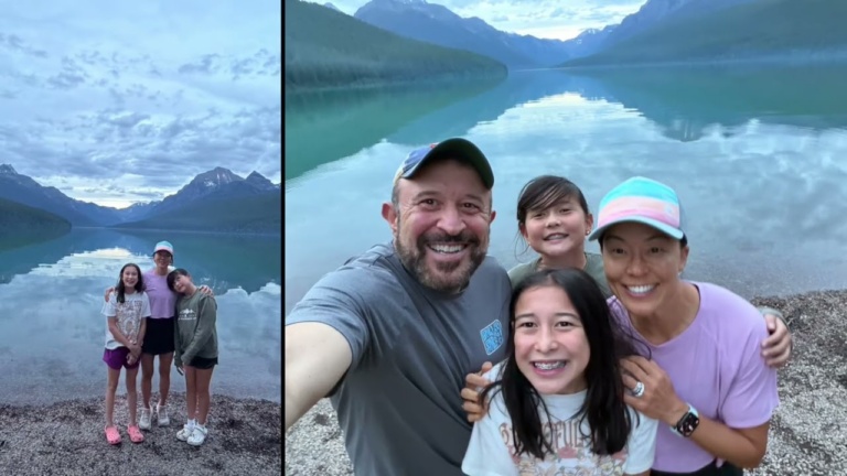 A family posing beside a glacial mountain lake